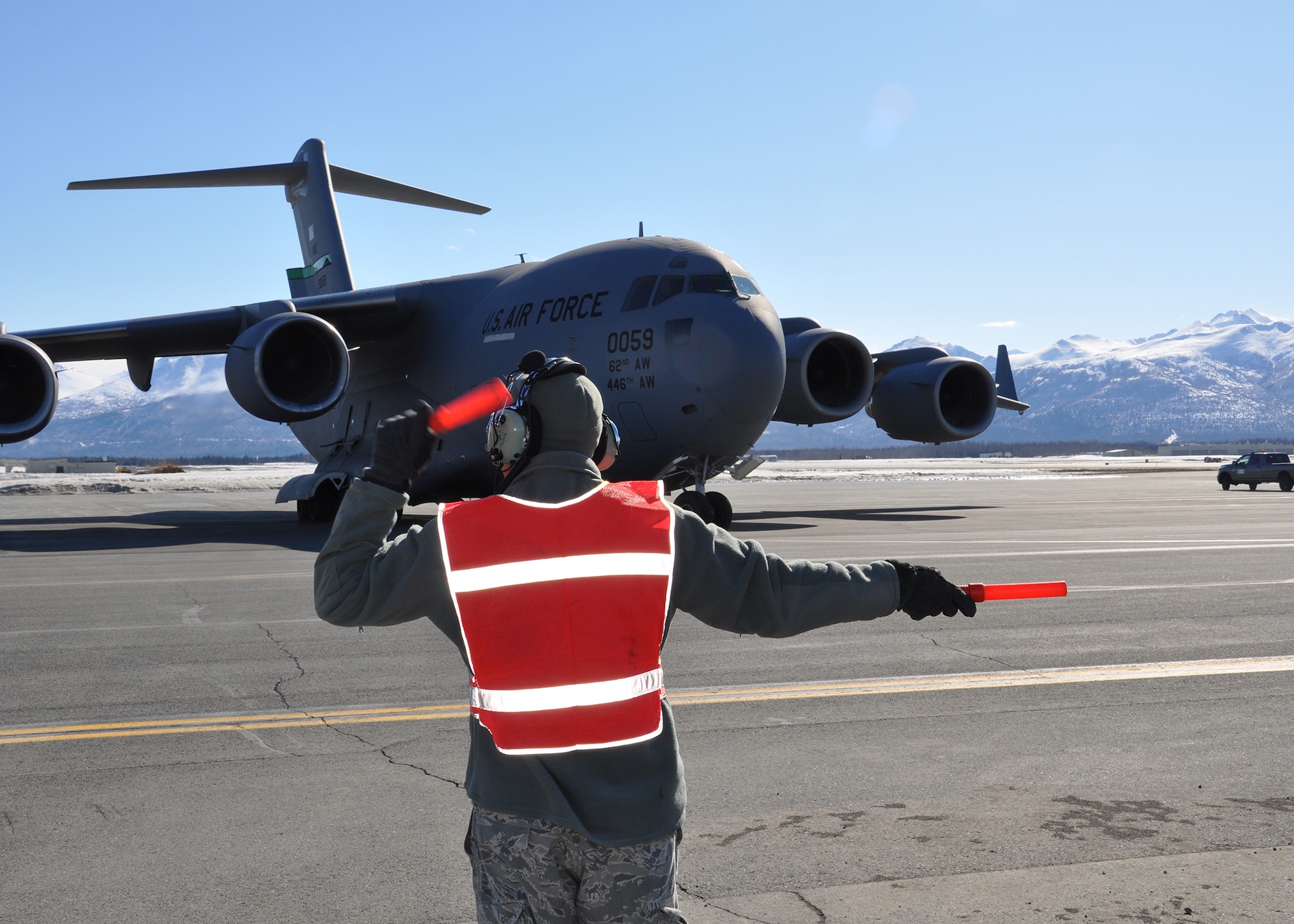 Tech. Sgt. Eddie Maldonado, 446th Aircraft Maintenance Squadron aircraft maintenance technician out of McChord Field, Wash., marshals a McChord C-17 Globemaster III aircraft for takeoff at Joint Base Elmendorf-Richardson, Alaska, April 25.  Maldonado and other Reservists from the 446th AMXS were at JBER fulfilling their two-week annual training requirements with the 732nd Air Mobility Squadron, JBER, April 21 to May 5. (U.S. Air Force photo/Tech. Sgt. Dana Rosso)
