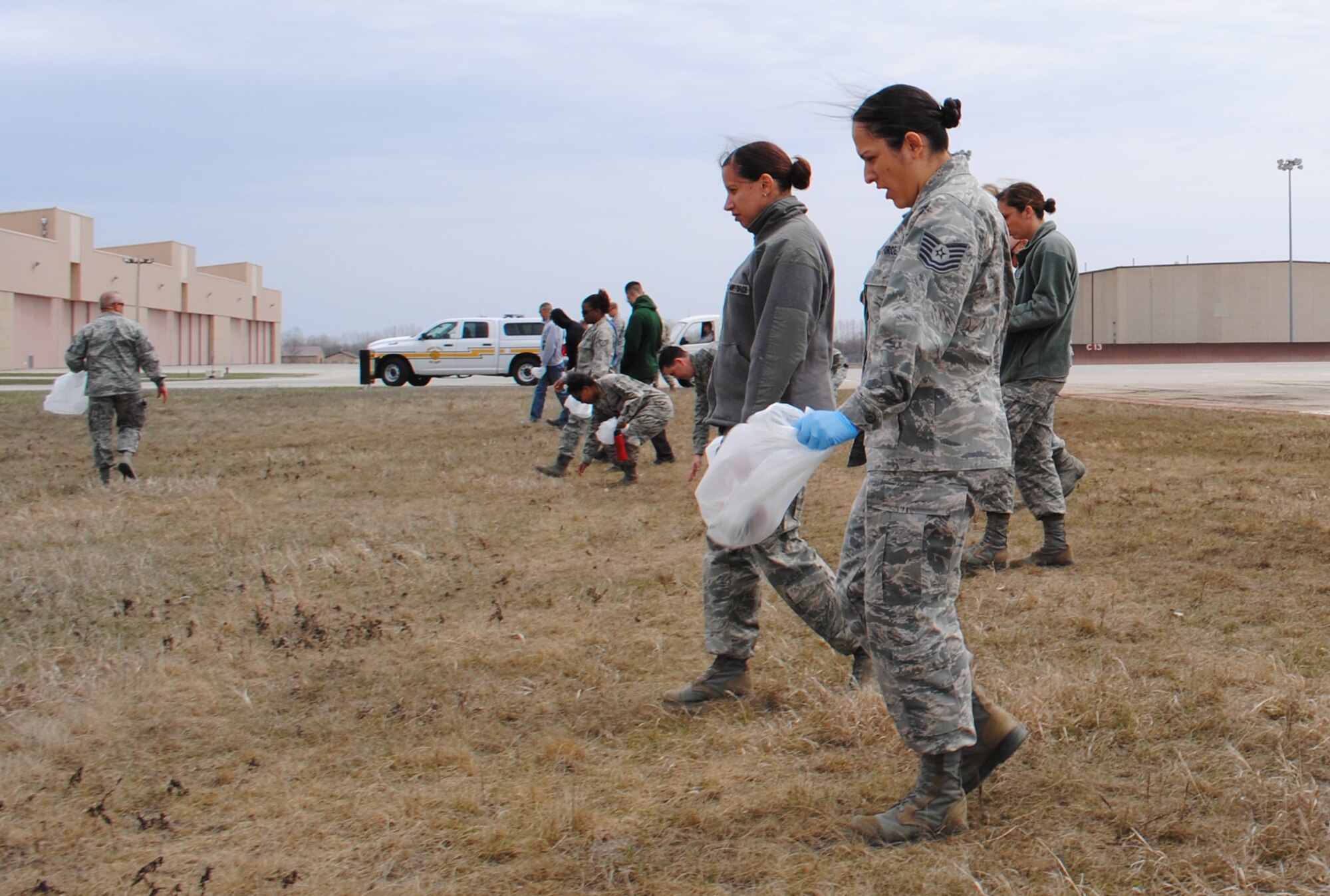 More than 120 officer and enlisted members take part in a FOD (foreign objects or debris) walk of the flightline on Grand Forks Air Force Base, N.D., May 10, 2013. A FOD walk is a large-scale inspection conducted by a long line of people walking side-by-side to identify and remove foreign objects and debris from a flightline that may cause damage to aircraft systems, weapons or injury to personnel. (U.S. Air Force photo/Staff Sgt. Luis Loza Gutierrez)
