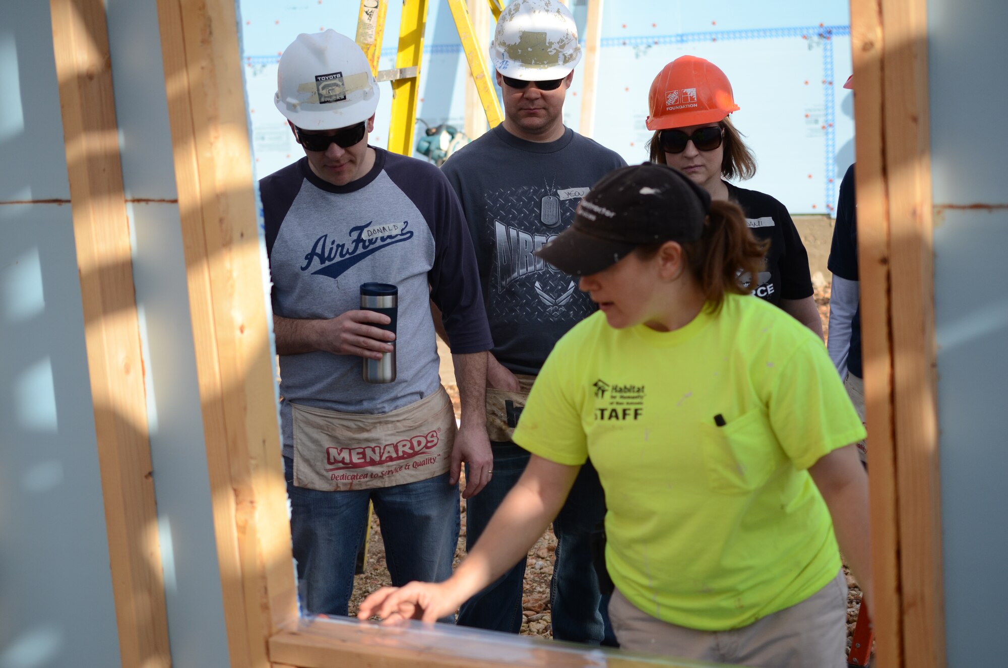 Val Hendricks, Habitat for Humanity staff member, instructs members of Air Force Recruiting Service on how to properly install windows on a home under construction in San Antonio, Texas May 11. Several members of AFRS volunteered their Saturday to assist Habitat for Humanity. The house is scheduled for completion in August. Habitat for Humanity seeks volunteers to help build and landscape affordable homes for qualified low-income families. (U.S. Air Force photo/Staff Sgt. Hillary Stonemetz)
