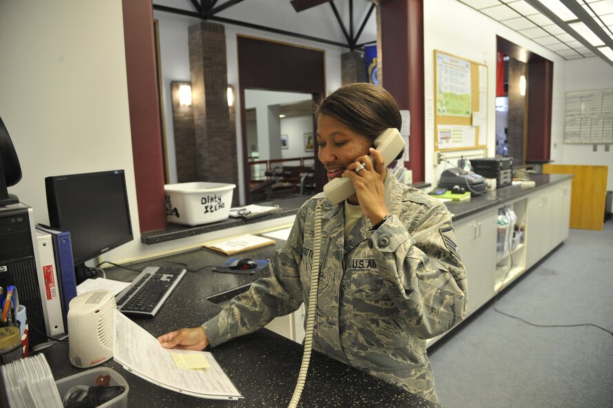 Master Sgt. Paula Statton , 509th FSS flight chief, looks at personnel training session packages at the fitness center on Whiteman Air Force Base, April 22, 2013. Every month, fitness center personnel must examine the rates for costs per person to keep track of how much money is made. (U.S. Air Force photo by Airman 1st Class Keenan Berry/Released)
