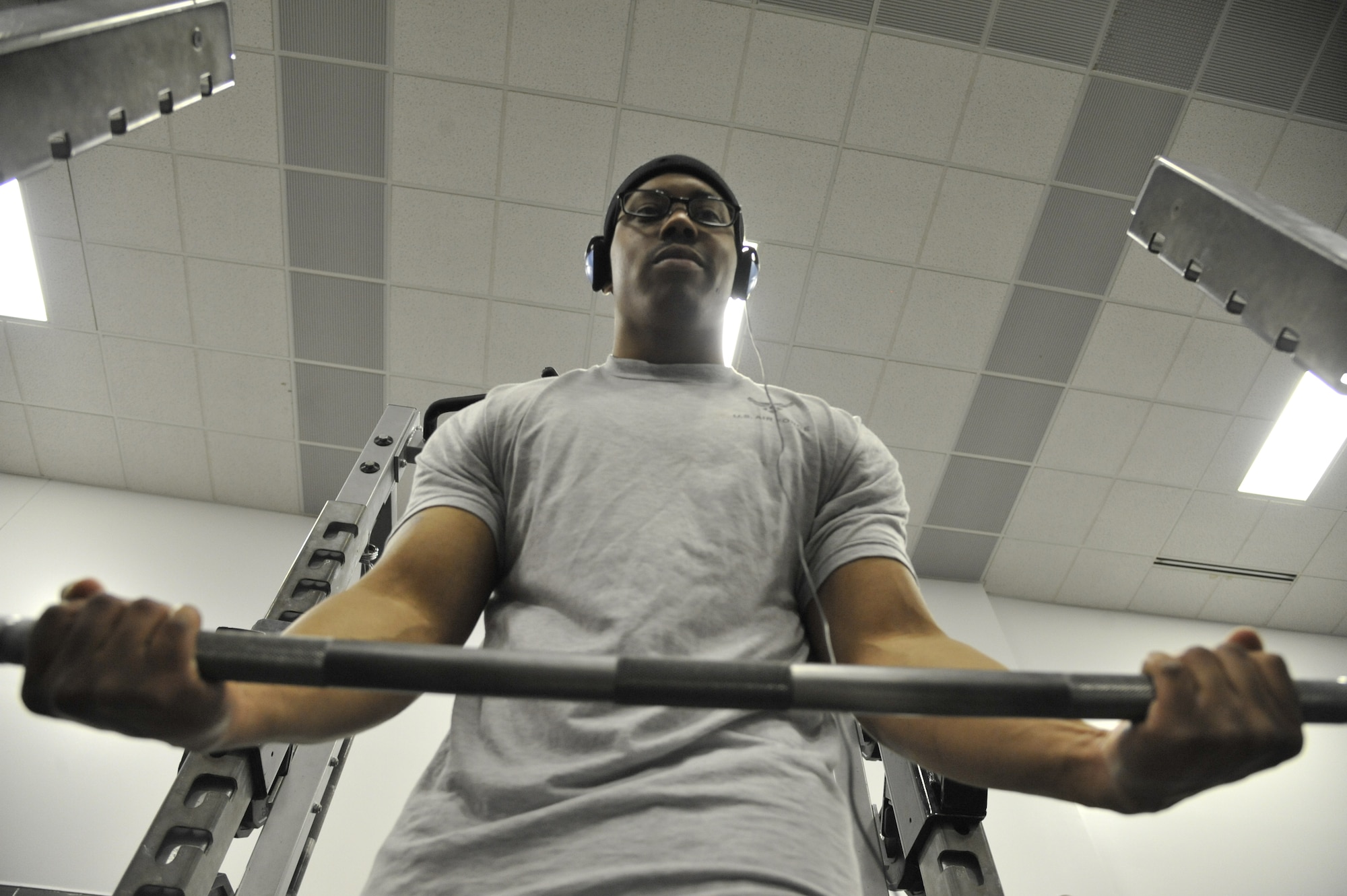 Senior Airman Adrian Paisley, 509th FSS fitness specialist, lifts a weight bar at the fitness center on Whiteman Air Force Base, April 22, 2013. This type of exercise strengthens the muscles within the forearms, brachioradialis and the flexor carpi radialis. (U.S. Air Force photo by Airman 1st Class Keenan Berry/Released)
