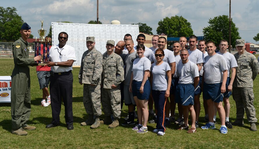 Airmen from the 2nd Maintenance Squadron pose for a photo with Col. Reid Langdon, 2nd Bomb Wing vice commander, during the 2013 Sports Day trophy ceremony on Barksdale Air Force Base, La., May 10, 2013. The Airmen from the 2nd MXS took first place for the competition. (U.S. Air Force photo/Senior Airman Micaiah Anthony)