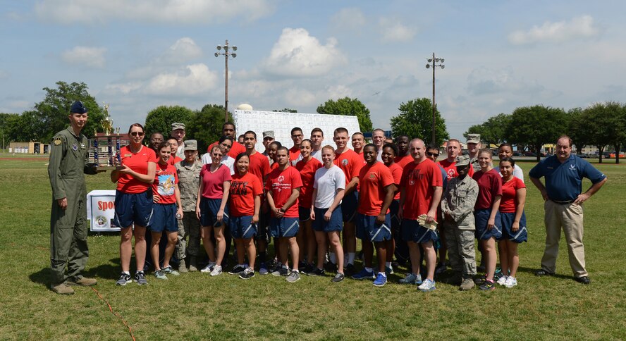 Airmen from the 2nd Force Support Squadron pose for a photo with Col. Reid Langdon, 2nd Bomb Wing vice commander, during the 2013 Sports Day trophy ceremony on Barksdale Air Force Base, La., May 10, 2013. The Airmen from the 2nd FSS placed second overall for the competition. (U.S. Air Force photo/Senior Airman Micaiah Anthony) 