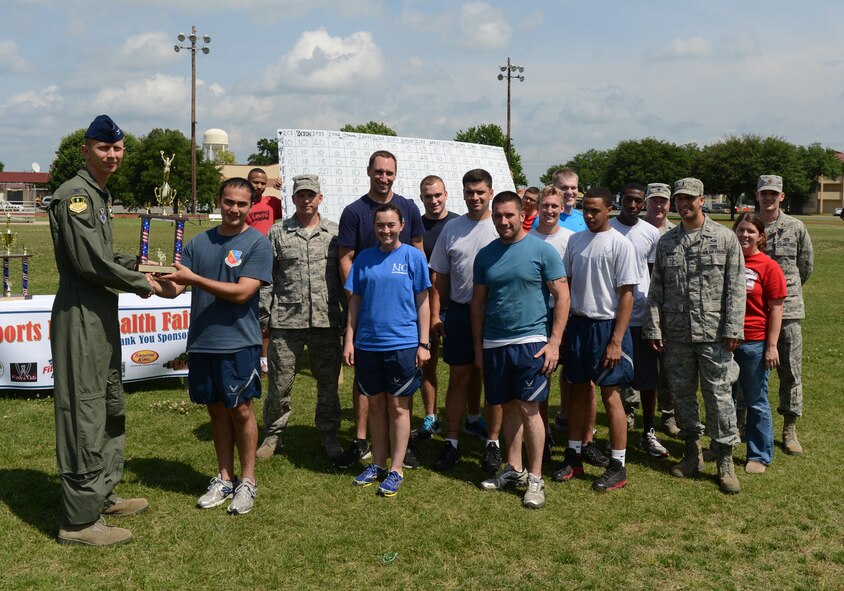 Airmen from the 2nd Civil Engineer Squadron pose for a photo with Col. Reid Langdon, 2nd Bomb Wing vice commander, during the 2013 Sports Day trophy ceremony on Barksdale Air Force Base, La., May 10, 2013. The Airmen from the 2nd CES placed third overall for the competition. (U.S. Air Force photo/Senior Airman Micaiah Anthony)