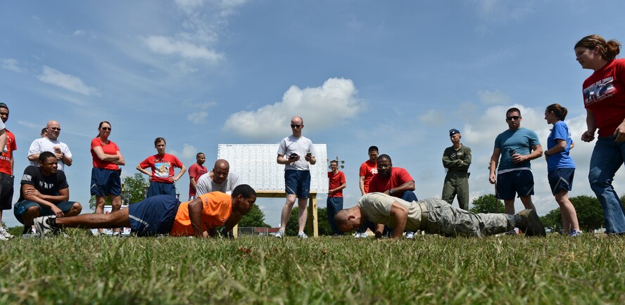 Senior Airman Scott Hewlett, 2nd Munitions Squadron, and 1st Lt. Cameron Bowsky, 2nd Civil Engineer Squadron, battle it out in a push-up competition during the 2013 Sports Day on Barksdale Air Force Base, La., May 10, 2013. In order to break the tie for third place, Airmen from 2nd MUNS and 2nd CES competed in a push-up and sit-up competition. (U.S. Air Force photo/Senior Airman Micaiah Anthony)