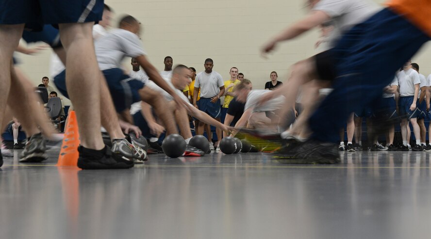 Participants in the dodgeball competition scramble to grab balls during the 2013 Sports Day on Barksdale Air Force Base, La., May 10, 2013. Sports Day consisted of various team events including dodgeball, tug-of-war, soccer, volleyball, basketball and a homerun derby. (U.S. Air Force photo/Senior Airman Micaiah Anthony)