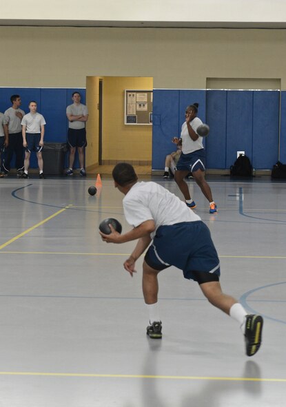 A participant in the dodgeball competition throws a ball at his opponent during the 2013 Sports Day on Barksdale Air Force Base, La., May 10, 2013. Sports Day is comprised of various competitive athletic events to help promote physical fitness. (U.S. Air Force photo/Senior Airman Micaiah Anthony)