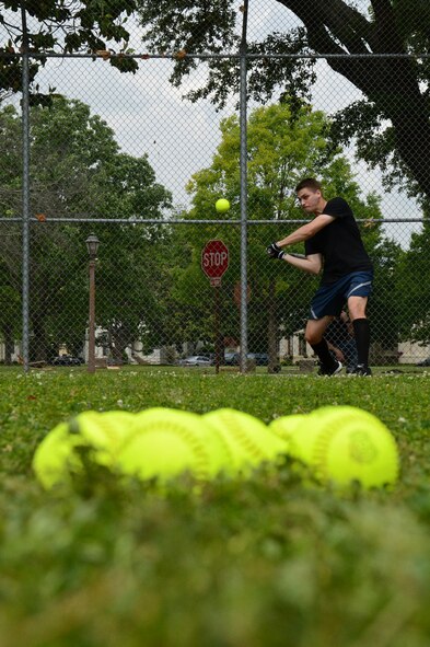 A participant in the homerun derby swings a bat to hit a ball during the 2013 Sports Day on Barksdale Air Force Base, La., May 10, 2013. Participants where given 10 pitches to try and get as many homeruns as possible.  (U.S. Air Force photo/Senior Airman Micaiah Anthony)