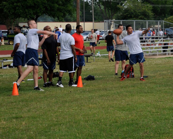 Airmen throw footballs during Sports Day on Barksdale Air Force Base, La., May 10, 2013. Sports Day is an annual event that gives Airmen the opportunity to participate in several individual and team sports to boost morale and camaraderie. (U.S. Air Force photo/Airman 1st Class Andrew Moua)