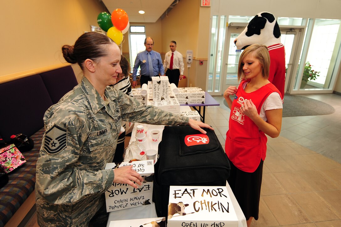 U.S. Air Force Master Sgt. Amanda Limmer, 343rd Recruiting Squadron, gives a Chick-fil-A boxed lunch to Nikkoll Wilkens, an older infant teacher with the Child Daycare Center, as part of Daycare Provider Day catered by Chick-fil-A on May 8 at Offutt Air Force Base, Neb.  Chick-fil-A donated 154 prepared meals to Offutt daycare providers at both CDC locations.  (U.S. Air Force photo by Josh Plueger/Released)
