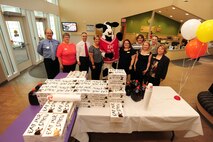 Child Daycare Center staff members stand side by side with members of Chick-fil-A catering for a group photo behind an airplane model constructed of dozens of boxed meals to be handed out to daycare staff members as a way to say thank you for the work they do on May 8 at Offutt Air Force Base, Neb.  Daycare provider day is held annually in May.  (U.S. Air Force photo by Josh Plueger/Released)