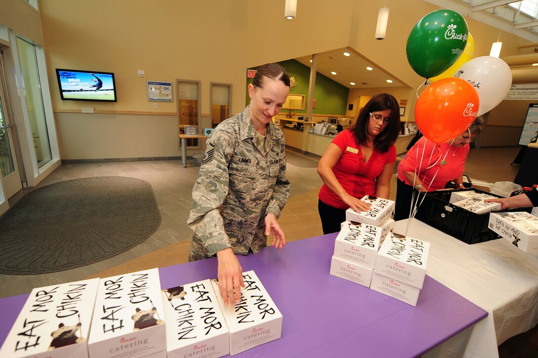 U.S. Air Force Master Sgt. Amanda Limmer, 343rd Recruiting Squadron, stacks 77 Chick-fil-A lunch boxes that were donated as a way to say thank you for the employees of the two Child Daycare Centers on May 8 at Offutt Air Force Base, Neb.  A total of 154 meals were provided by Chick-fil-A.  (U.S. Air Force photo by Josh Plueger/Released)