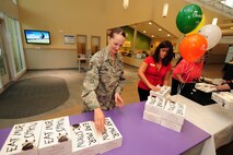 U.S. Air Force Master Sgt. Amanda Limmer, 343rd Recruiting Squadron, stacks 77 Chick-fil-A lunch boxes that were donated as a way to say thank you for the employees of the two Child Daycare Centers on May 8 at Offutt Air Force Base, Neb.  A total of 154 meals were provided by Chick-fil-A.  (U.S. Air Force photo by Josh Plueger/Released)