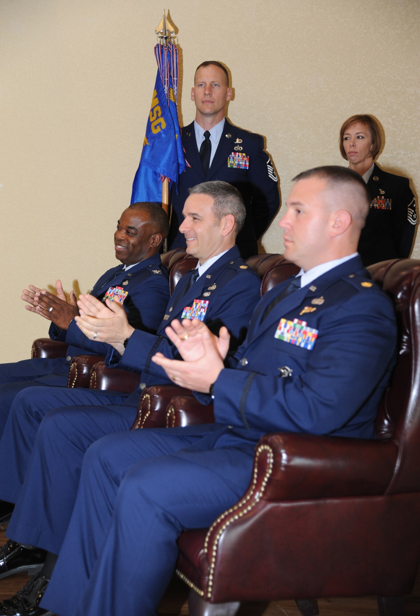 Col. Mark Vivians, 81st Mission Support Group commander; Maj. Matthew Pignataro, outgoing 81st Security Forces Squadron commander, and Maj. Brian Fitzpatrick, incoming 81st SFS commander, applaud during the 81st SFS change of command ceremony May 13, 2013, at the Bay Breeze Event Center, Keesler Air Force Base, Miss.  Vivians served as the presiding officer for the event.  (U.S. Air Force photo by Kemberly Groue)