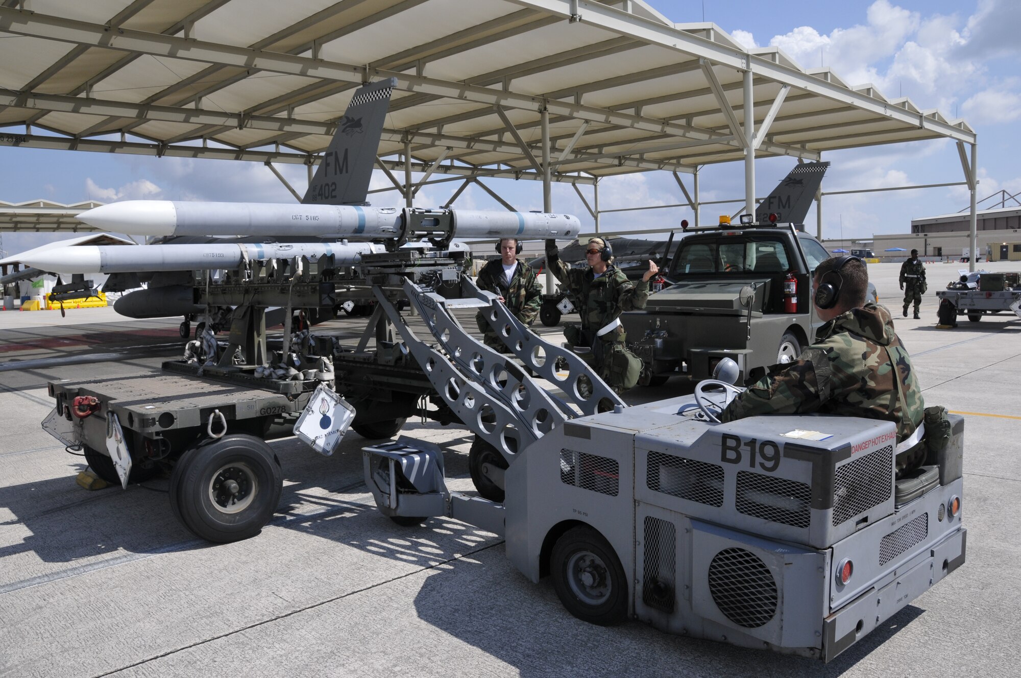 Airmen from Homestead Air Reserve Base, Fla. load an inert weapon on an F-16 during an Operational Readiness Inspection in 2012. Homestead ARB recently conducted a series of Live Ordnance Loading Area operations. More commonly known as LOLA, the operations consist of loading live ordnance on F-16s in an authorized area on the flightline away from people and buildings. Once the flying schedule calls for live munitions on flying sorties, the aircraft are positioned on the LOLA and weapons load crews are dispatched to perform the live loading operations. The aircraft remain on LOLA until takeoff or until live munitions have been downloaded. (U.S. Air Force photo/Tim Norton)