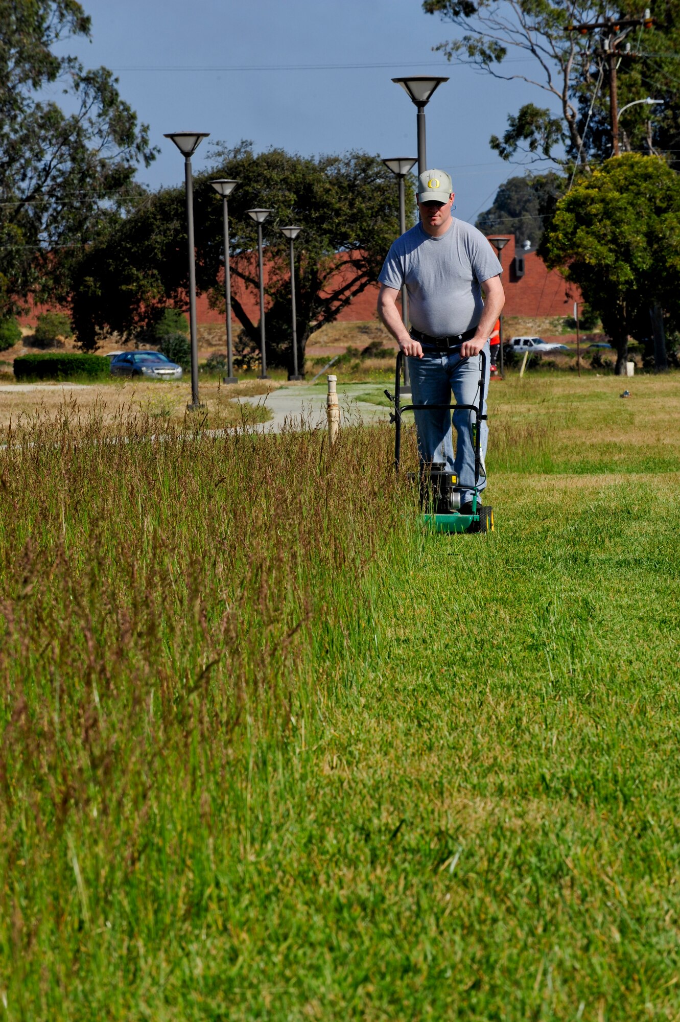 VANDENBERG AIR FORCE BASE, Calif. – Tech. Sgt. Joel Ehlert, 30th Security Forces Squadron non commission officer in charge of planning, cuts grass along Utah Avenue for Mission Support Group Pride Day here Friday, May 10, 2013. The MSG Pride Day consisted of more than 80 volunteers with lawnmowers, weed eaters, gloves and trash bags to restore the bases appearance due to budgetary cuts. “The volunteers that have mowed already, and the ones working tomorrow, are restoring the bases appearance that we all expect. After all, our base appearance is a reflection of us as an organization and team,” said Chief Master Sgt. Patrick Abbott, 30th Mission Support Group superintendant. “Its events like this one, and many other ‘spontaneous acts of mowing,’ that show just how much pride we have in our community, Vandenberg AFB and our mission here.” (U.S. Air Force photo/Airman Yvonne Morales)