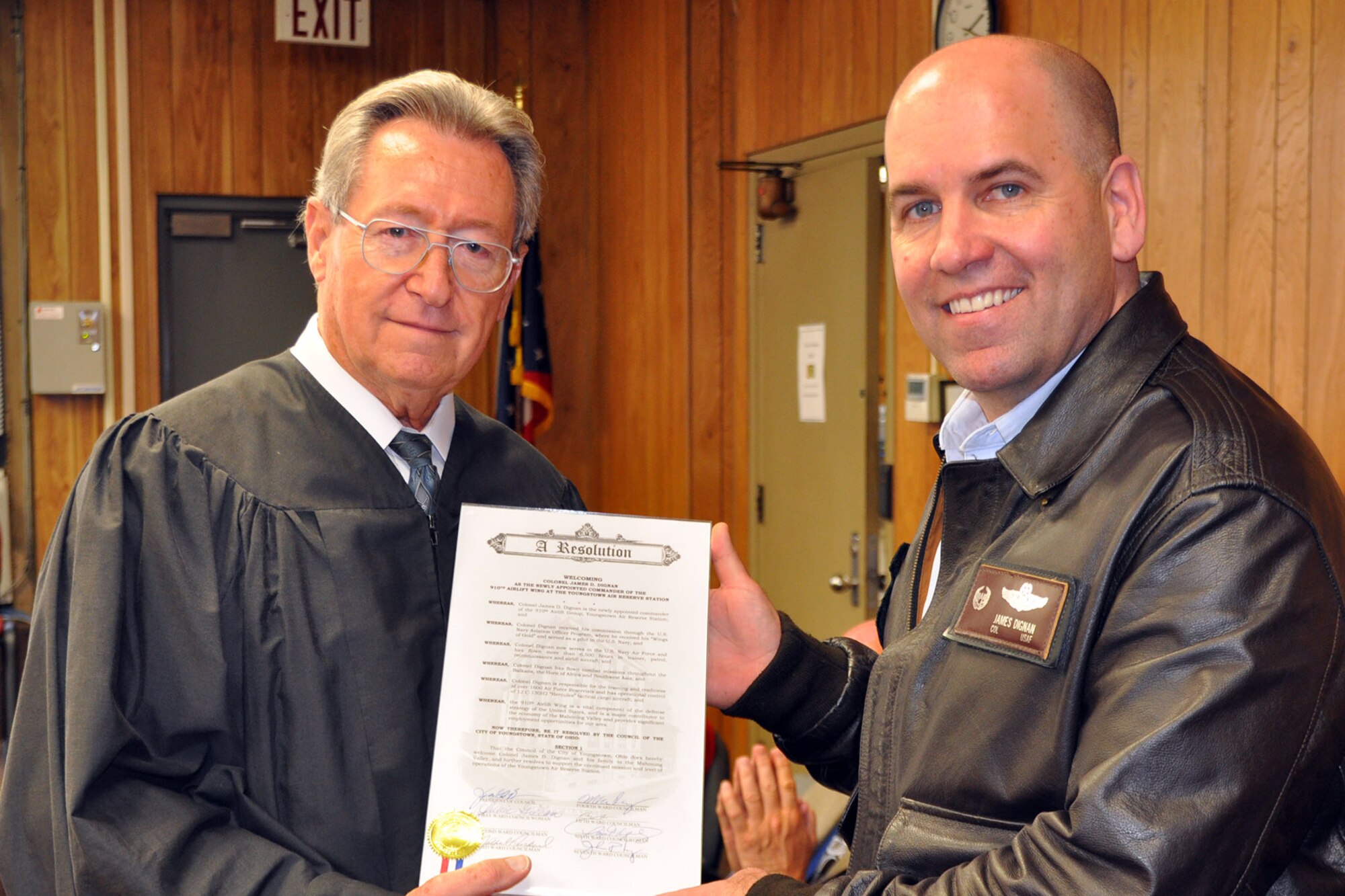 YOUNGSTOWN CITY HALL, Ohio -- Col James Dignan, commander of the 910th Airlift Wing, based at nearby Youngstown Air Reserve Station, Ohio (right), receives a resolution from the City of Youngstown, presented by Judge Robert P. Milich in Municipal Courtroom 2 here, May 8, 2013. The resolution in part read ‘The Council of the City of Youngstown hereby welcomes Colonel James D. Dignan and his family to the Mahoning Valley and further resolves to support the continued missions and levels of operations of the Youngstown Air Reserve Station.’ Col. Dignan visited Judge Milich’s courtroom here to observe a session of the Youngstown Municipal Veteran Treatment Court as part of the commander’s outreach to civic leaders in surrounding communities. The goal of the Youngstown Municipal Veteran Treatment Court is ‘to provide necessary treatment, support and services to veterans involved in the criminal justice system so they may obtain and maintain stable, law-abiding and healthy lives; thereby becoming positive and productive members of the community.’ U.S. Air Force photo by Master Sgt. Bob Barko Jr.