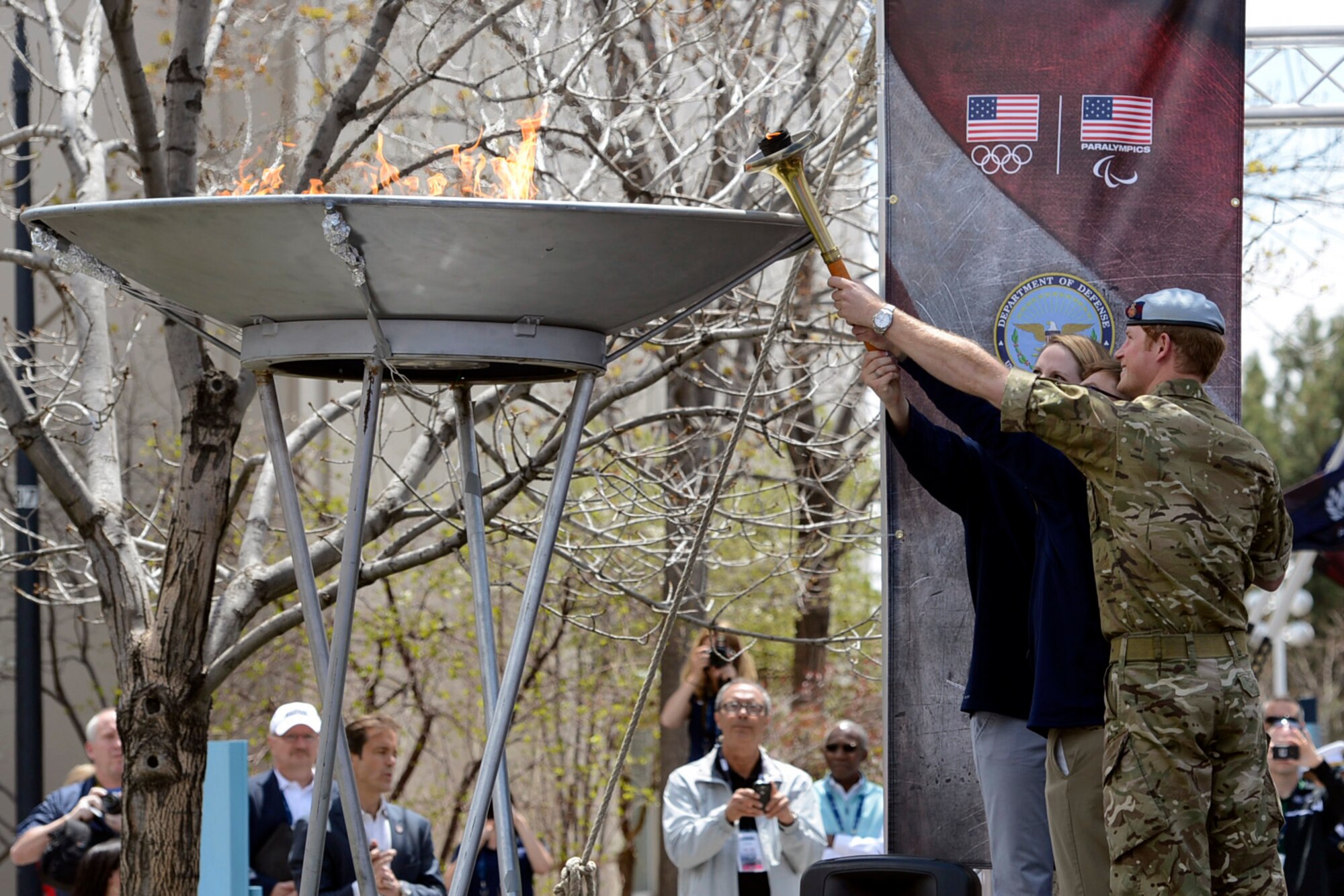 Paralympian gold medal winner Navy Lt. Bradley Snyder, with the help of Prince Harry and olympian Missy Franklin, light the official torch to begin the 2013 Warrior Games at the U.S. Olympic Training Center in Colorado Springs, Colo., May 11, 2013. From May 11-16, more than 200 wounded, ill and injured Service members and veterans from the U.S. Marines, Army, Air Force and Navy, as well as a team representing U.S. Special Operations Command and an international team representing the United Kingdom, will compete for the gold in track and field, shooting, swimming, cycling, archery, wheelchair basketball and sitting volleyball at the U.S. Olympic Training Center and U.S. Air Force Academy. The military service with the most medals will win the Chairman's Cup. (U.S. Army photo by EJ Hersom/Released)