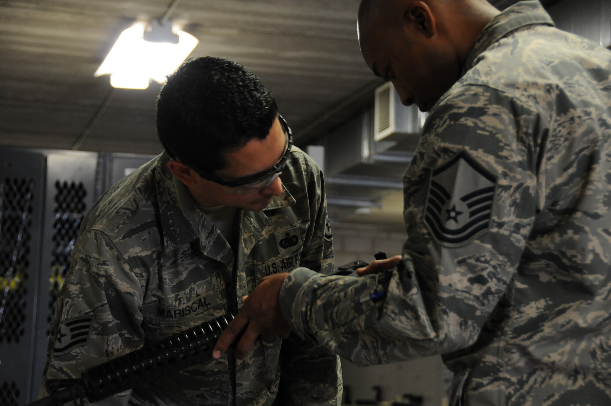 944th member check his weapon as it is issued during a two-day deployment exercise.
