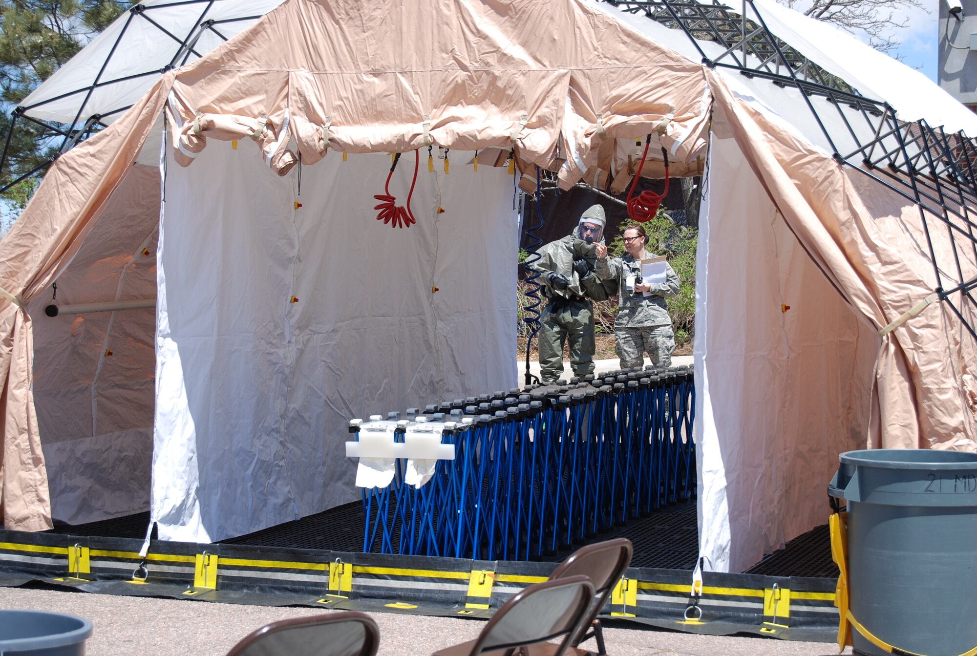 With the decontamination tent setup and ready, personnel from the 21st Medical Group coordinate decontamination of the Airmen. From there the injured were given hands-on medical care. (U.S. Air Force photo/Michael Golembesky)