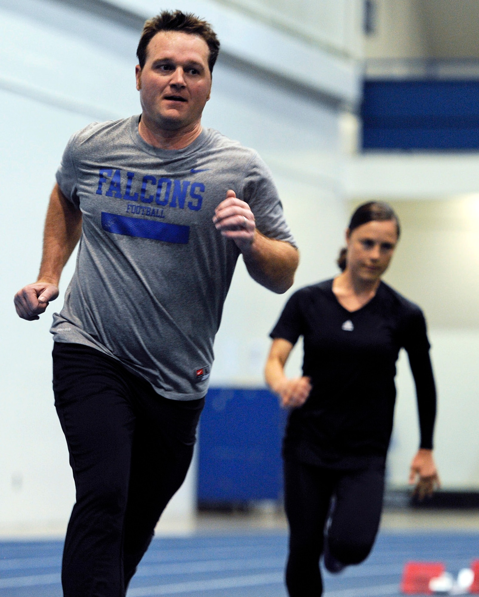 Capt. Wesley Glisson (foreground) and Staff Sgt. Lara Ishikawa run laps at the Academy indoor track during the Wounded Warrior Games Training Camp held in Colorado Springs, Colo., April 19, 2013. Glisson and Ishikawa are assigned to Joint Base San Antonio-Lackland, Texas. (U.S. Air Force photo/Desiree N. Palacios)