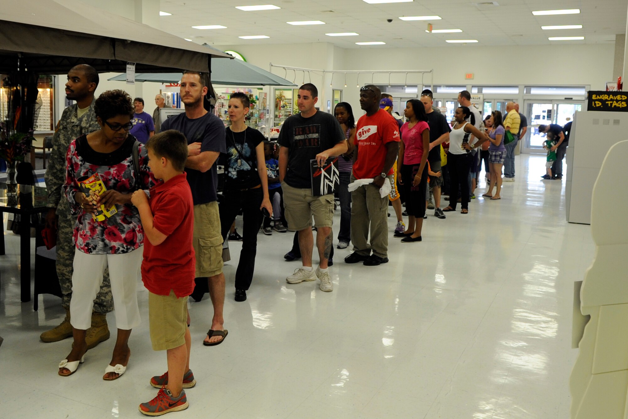 Fans of WWE Superstar and United States Champion Kofi Kingston, wait for their chance to meet the wrestler during a “meet and greet the troops” event at the Base Exchange on Barksdale Air Force Base, La., May 10, 2013. Later that evening, Kingston defeated Cody Rhodes during a WWE Smackdown event at the Hirsch Memorial Coliseum in Shreveport, La. (U.S. Air Force photo by Master Sgt. Jeff Walston/Released)