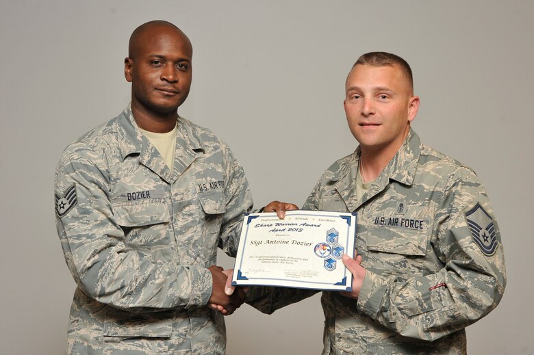 PETERSON AIR FORCE BASE, Colo. -- Master Sgt. Dan Stellabotte, on behalf of the Pikes Peak Top 3, presents the April Sharp Warrior Award to Staff Sgt. Antoine Dozier, Headquarters Air Force Space Command logistics planning. Dozier's creativity helped him develop a logistics billing database, which saved the command $500,000 annually. He completed three credit hours towards his bachelor’s degree in transportation logistics management and a logistics course. Dozier also assisted in the Combined Federal Campaign and played a key role on the A4R intramural basketball team over-30 basketball championship. The Sharp Warrior Award is awarded each month in recognition of Team Peterson’s best. Any first sergeant or senior NCO serving as a first sergeant who observes outstanding performance may nominate someone for the award to the first sergeants council. (U.S. Air Force photo)