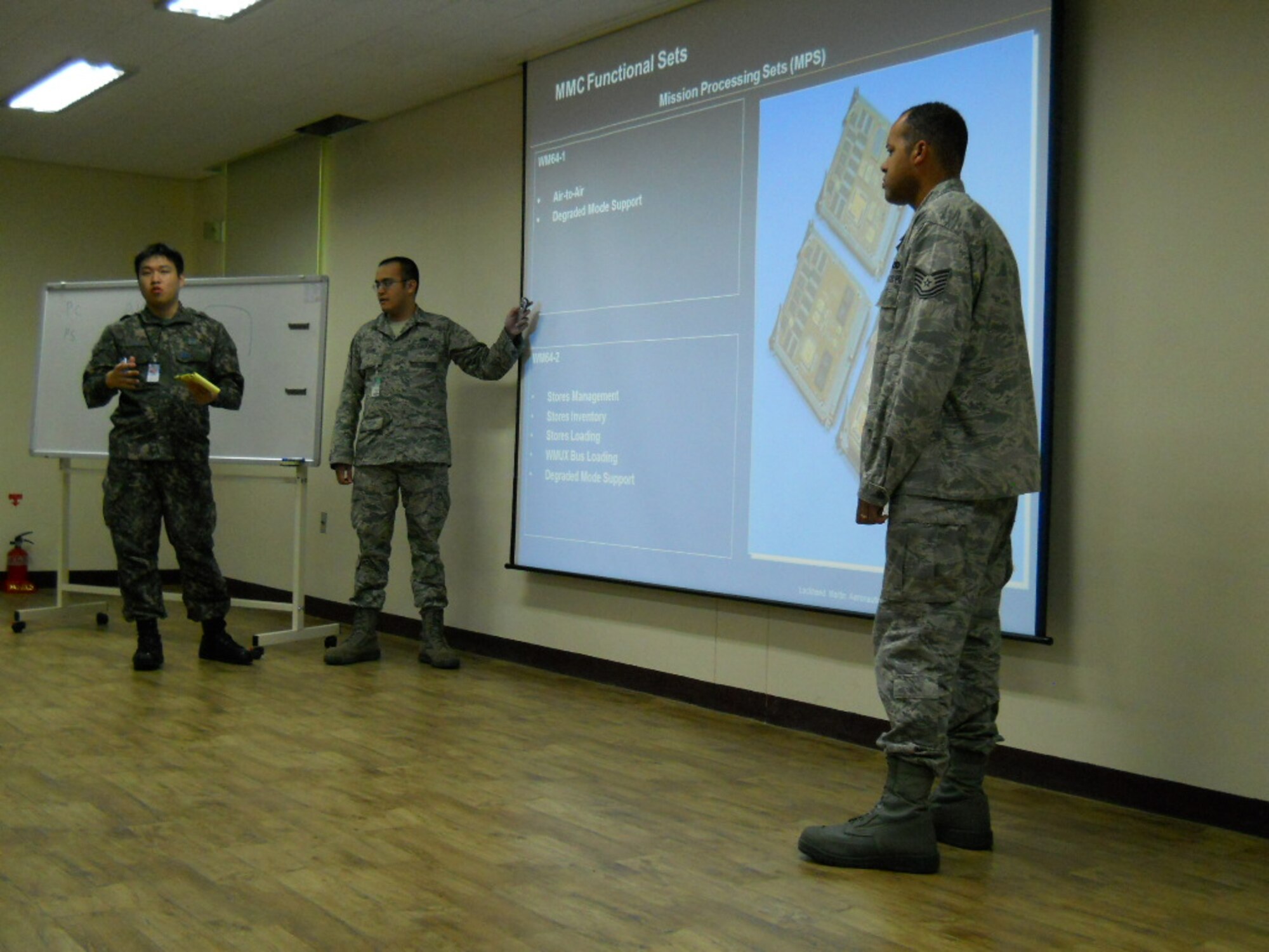 Tech. Sgt. Jason Perrin (left), 372nd TRS Det 212 at Luke Air Force Base, Ariz., and Tech. Sgt. Jaamal MeNefee, 372nd Ttraining Squadron Det 213 at Nellis Air Force Base, Nev., teach Republic of Korea personnel  about F-16 avionics systems upgrades at Joongwon Air Base in ChungJu, South Korea in May, 2013.  The two airmen were part of a 372nd TRS mobile training team. (U.S. Air Force courtesy photo)