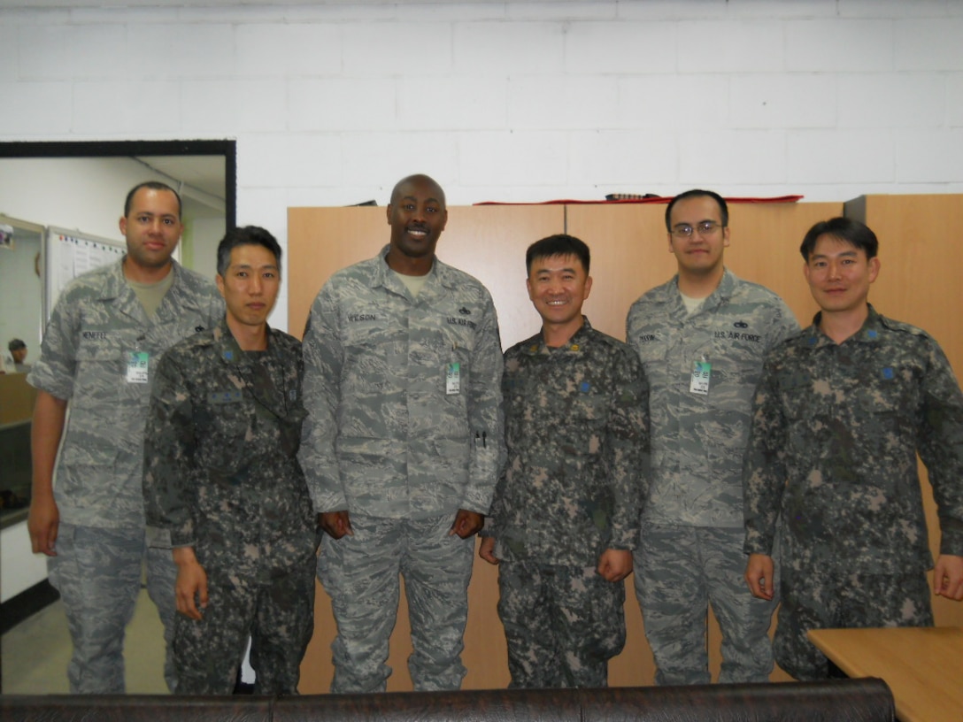 (left to right) Tech. Sgt. Jaamal MeNefee, 372nd Ttraining Squadron Det 213 at Nellis Air Force Base, Nev., Master Sgt. Marco D. Wilson from the 372 TRS Det 202 at Shaw Air Force Base, S.C. and Tech. Sgt. Jason Perrin, 372nd TRS Det 212 at Luke Air Force Base, Ariz., with unidentified Republic of Korea Air Force personnel at Joongwon Air Base in ChungJu, South Korea in May, 2013.  The three airmen were part of a 372nd TRS mobile training team teaching F-16 avionics systems upgrades to the ROKAF. (U.S. Air Force courtesy photo)