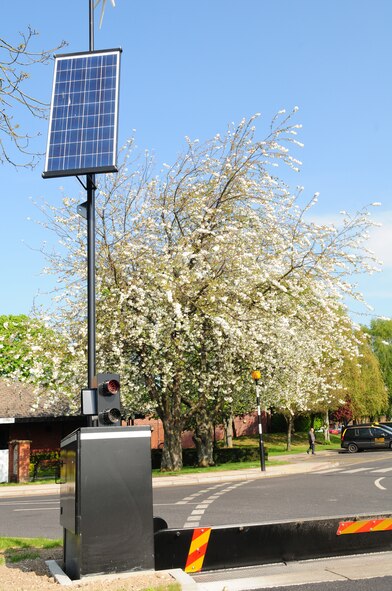 New barriers to aid and increase force protection are being installed around RAF Mildenhall, England. The new, “green” barriers are solar- and wind-powered and are saving the base many thousands of dollars, as they do not run on electricity as other types of barriers do. They will be used to filter and control vehicles, and allow the base to be divided into sectors, allowing the flow of traffic around base to still run freely. (U.S. Air Force photo by Karen Abeyasekere/Released)