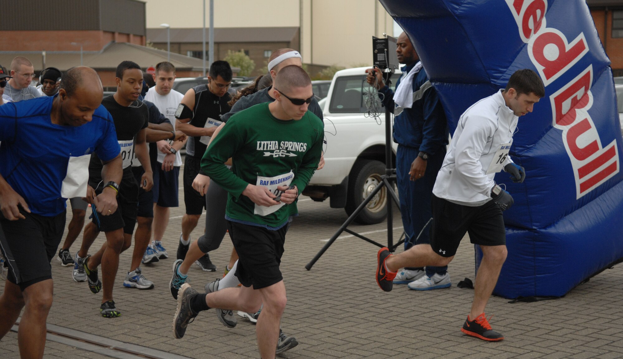 Team Mildenhall members begin a half-marathon May 11, 2013, at RAF Mildenhall, England. Starting and finishing in front of the Hardstand Fitness Center on base, the half-marathon spanned 13.1 miles. (U.S. Air Force photo by Airman 1st Class Dillon Johnston/Released)