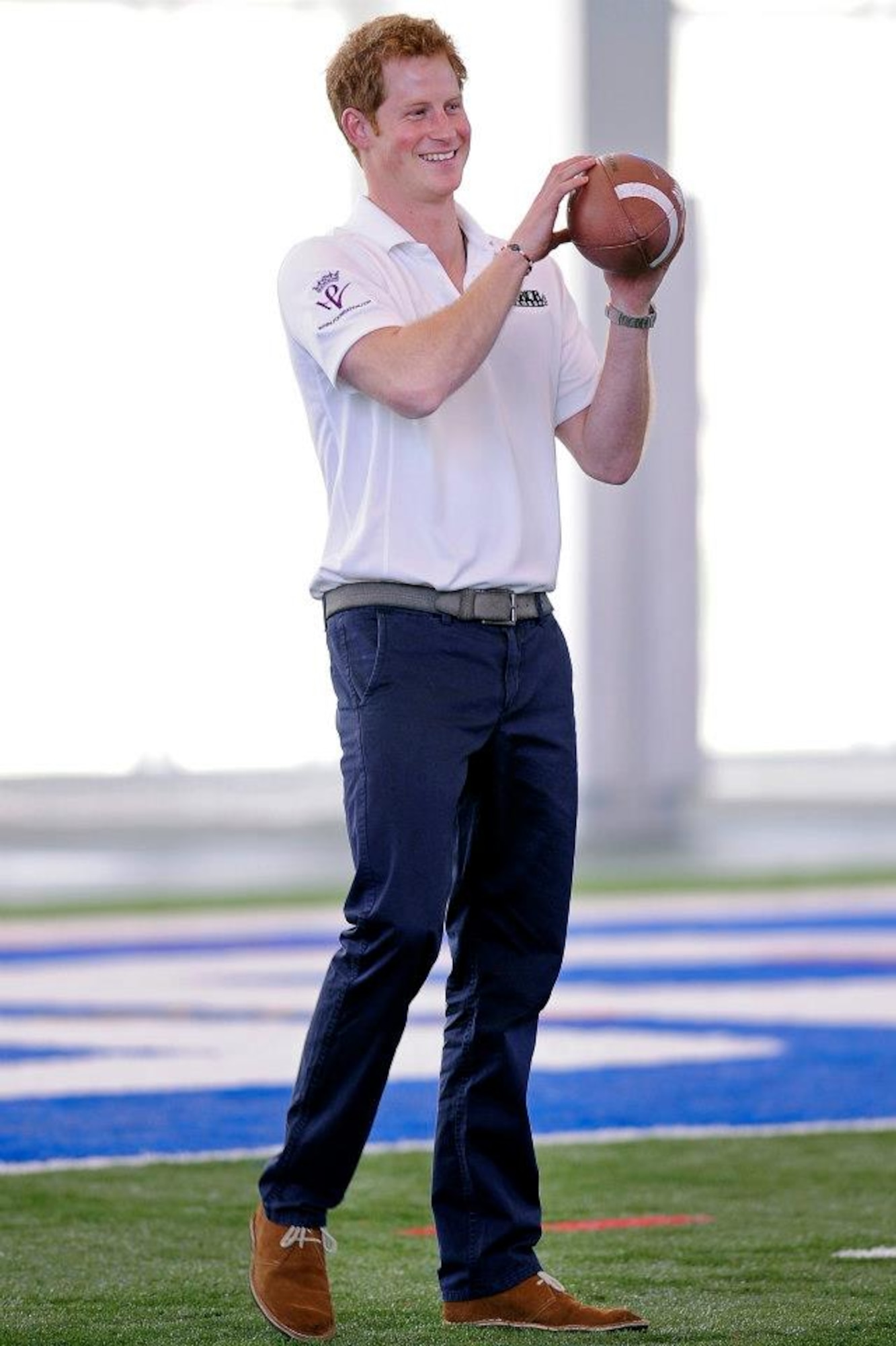 His Royal Highness Prince Henry of Wales throws around a football, American style, during his visit to the Academy May 12. Prince Harry made a stop in Colorado Springs and the Academy during his week-long visit to the United States to raise awareness for Warrior Games, which are taking place here and at the U.S. Olympic Training Center throughout the week. (U.S. Air Force photo/Sarah Chambers)