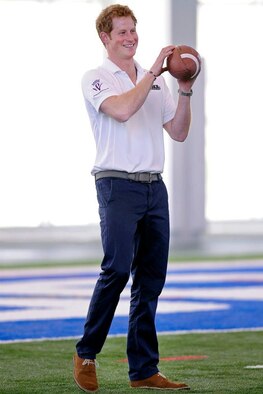 His Royal Highness Prince Henry of Wales throws around a football, American style, during his visit to the Academy May 12. Prince Harry made a stop in Colorado Springs and the Academy during his week-long visit to the United States to raise awareness for Warrior Games, which are taking place here and at the U.S. Olympic Training Center throughout the week. (U.S. Air Force photo/Sarah Chambers)