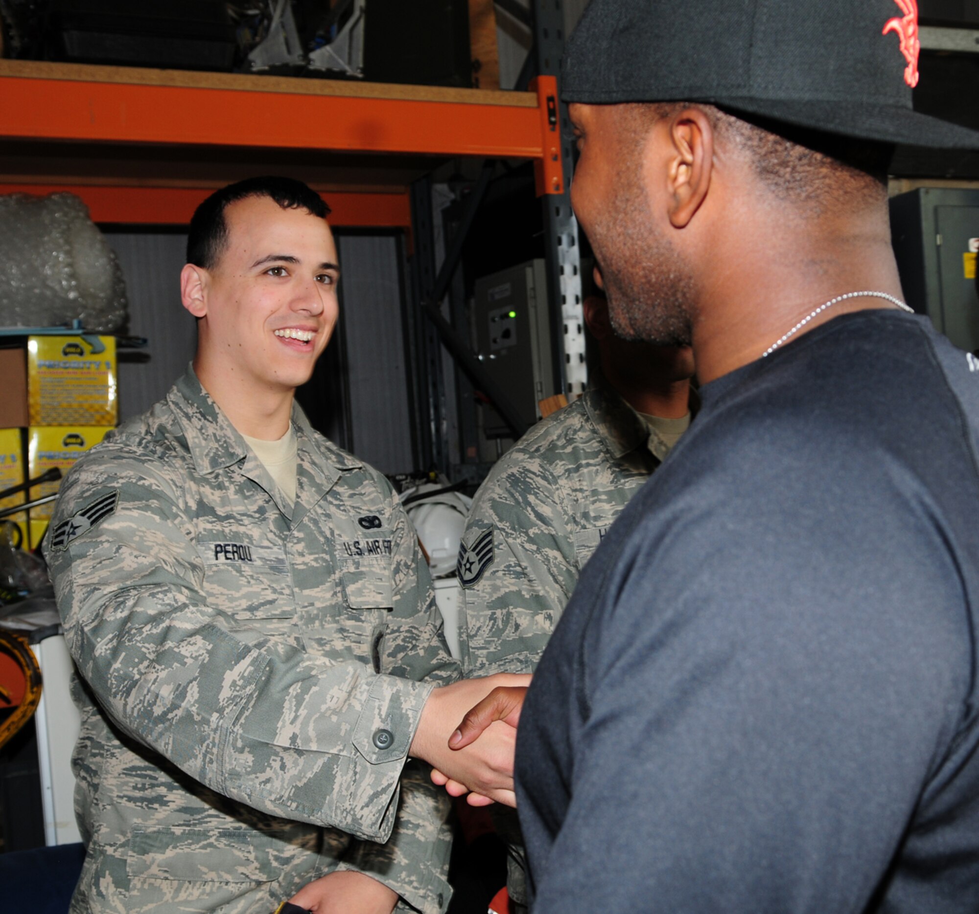 From left, Senior Airman Jerimiah Perou, 100th Security Forces Squadron member from Fort Collins, Colo., greets Airman 1st Class Christopher Simmons, 100th SFS response force member from Greensboro, N.C., as he returns to RAF Mildenhall, England, from a six-month deployment May 10, 2013, in support of Operation Enduring Freedom. Service members from the 100th SFS returned home to their friends and families May 9 to 11. (U.S. Air Force photo by Karen Abeyasekere/Released)