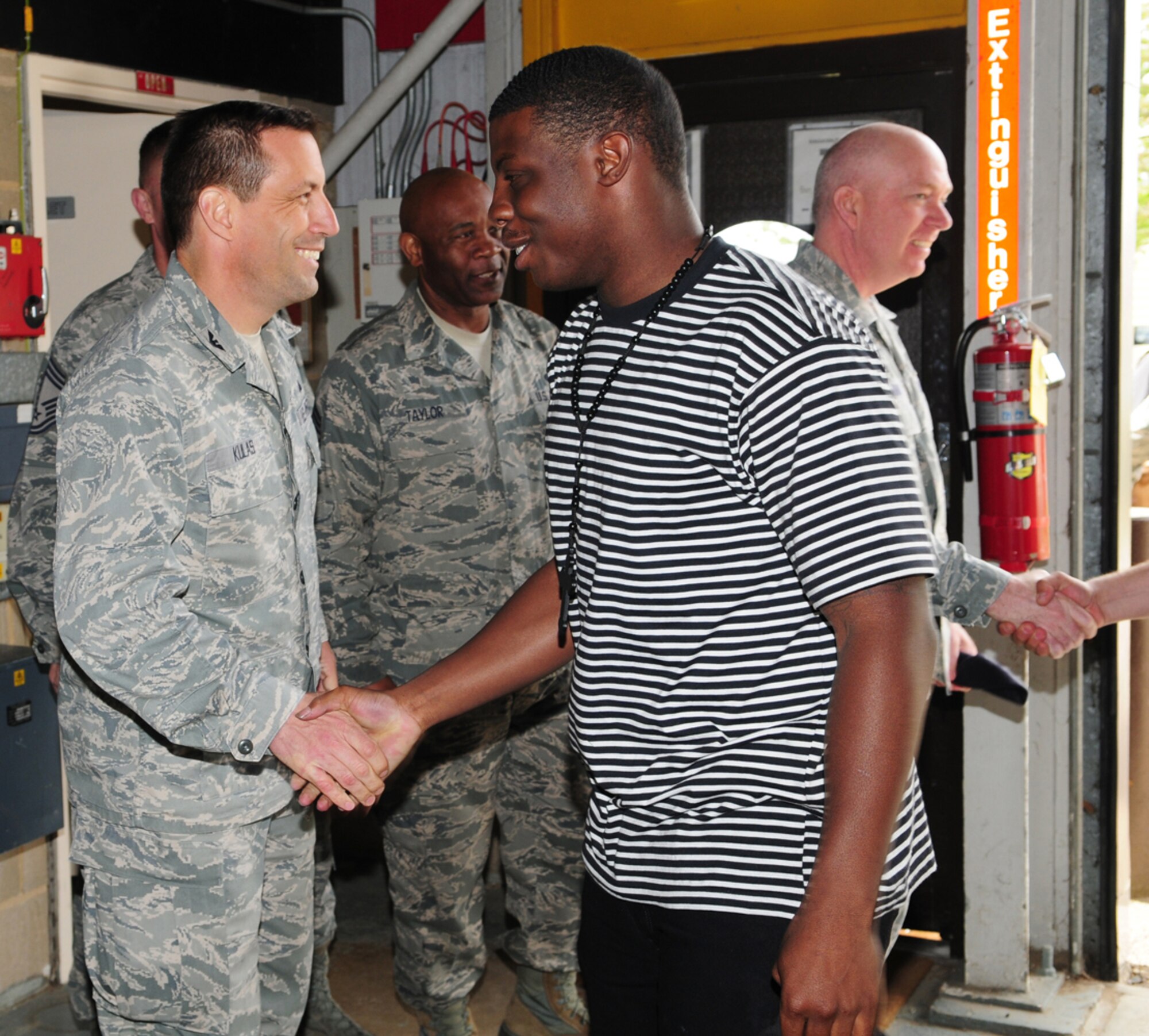 Leadership from the 100th Air Refueling Wing greet 100th Security Forces Squadron Airmen as they return home to RAF Mildenhall, England, from a six month deployment May 9, 2013. Airmen from the 100th SFS were deployed in support of operations around the world. (U.S. Air Force photo by Karen Abeyasekere/Released)
