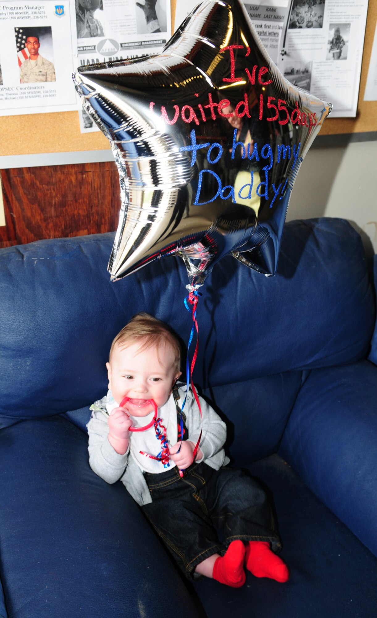 Konner Farmer, 7 months, waits patiently for his daddy, Staff Sgt. Gary Farmer, 100th Security Forces Squadron member, from Broomfield, Colo., to return from a six-month deployment to Afghanistan May 9, 2013, at RAF Mildenhall, England. Defenders from the 100th SFS returned May 9 to 11 and were greeted by their families, base leadership and fellow squadron members. (U.S. Air Force photo by Karen Abeyasekere/Released)