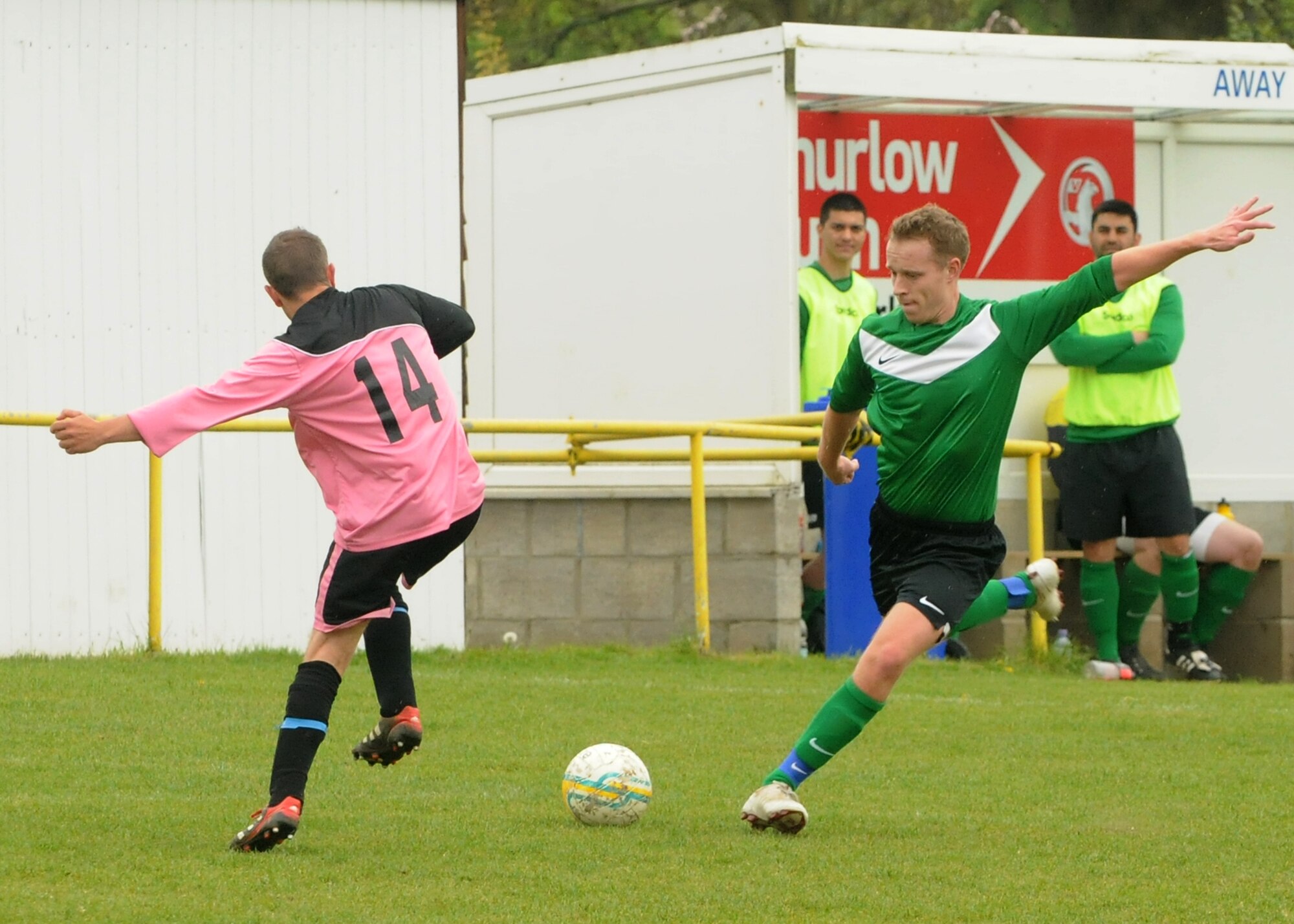 Senior Airman Shane Roten, 100th Aircraft Maintenance Squadron, RAF Mildenhall, kicks the ball away from a defender during a soccer match May 12, 2013, between Liberty Football Club and Racing Newmarket Jocky and Stable Lads Football Team in Newmarket, England. Liberty FC is the combined RAF Mildenhall and RAF Lakenheath soccer team. (U.S. Air Force photo by Tech. Sgt. Neal X. Joiner/Released)