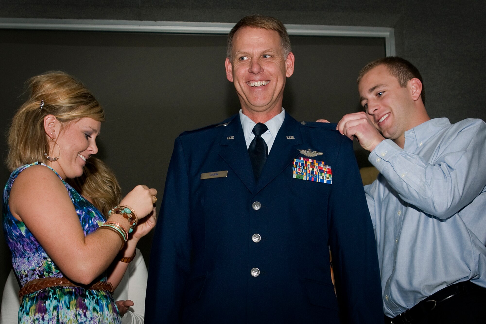 GRISSOM AIR RESERVE BASE, Ind. -- Chelsea and Austin Shaw pin silver eagle rank on their dad, Col. Larry H. Shaw III, center, during a special promotion ceremony here May 4. Shaw is currently the 434th Operations Support Squadron commander and will move on to a new position as 927th Operations Group commander at MacDill Air Force Base, Fla. (U.S. Air Force photo/Senior Airman Andrew McLaughlin) 