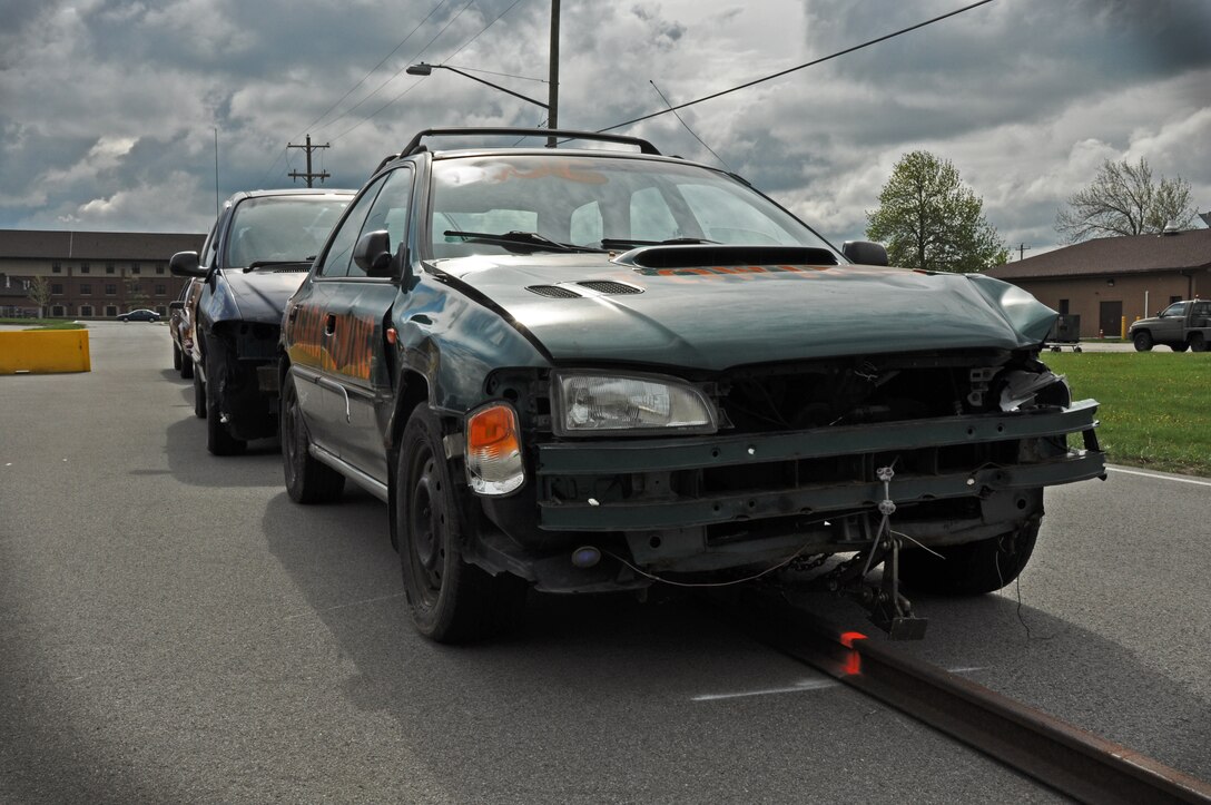 Demolition cars are lined up in preparation of Traffic Safety Week, May 13, 2013. Vehicles are staged in a controlled low speed collision to demonstrate to students of driving age the damage and possible fatality as a consequence of distracted or impaired driving. (U. S. Air Force photo by Staff Sgt Stephanie Clark)