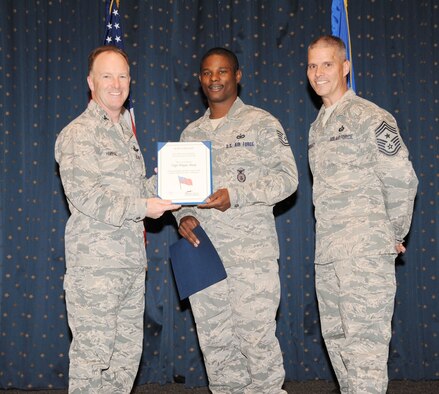 Tech. Sgt. Wayne Sharp, center, is the first Kirtland recipient of the Military Outstanding Volunteer of the Year Award, given to a service member who has provided outstanding support of community activities. (Photo by Dennis Carlson)