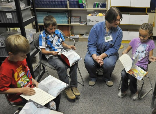 Louise Kelefian, Kirtland’s Volunteer Excellence Award winner, reads to kids at Sandia Base Elementary School. In addition to volunteering at the school, she works with the youth at the Child Development Center’s after school reading program. She volunteers in several other places throughout the base and local communities. (Photo by Ken Moore)