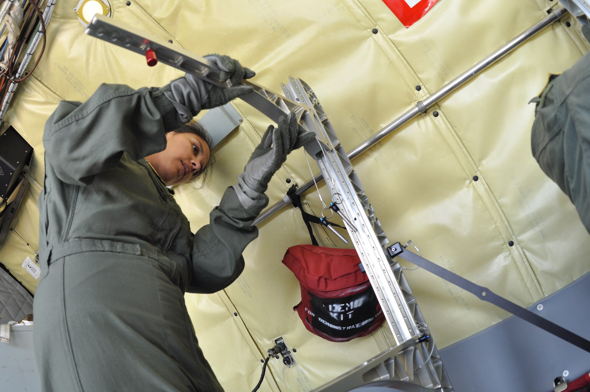 Capt. Diana Mazzota, a flight nurse with the 433rd Aeromedical Evacuation Squadron assembles a stanchion litter system during an aeromedical evacuation training aboard a KC-135, May 11.