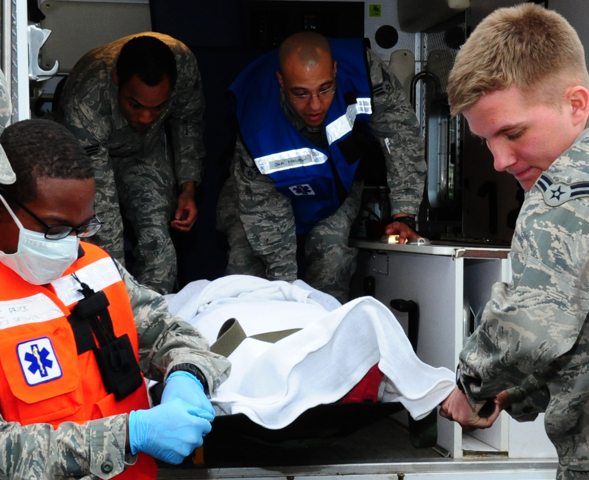 Members of the 35th Medical Group transport a simulated victim for emergency treatment during an Emergency Management Exercise at Misawa Air Base, Japan, May 13, 2013.  In the case of a real-world emergency, exercises prepare Misawa's Airmen to be ready at a moment’s notice.  (U. S. Air Force photo by Staff Sgt. April Quintanilla)