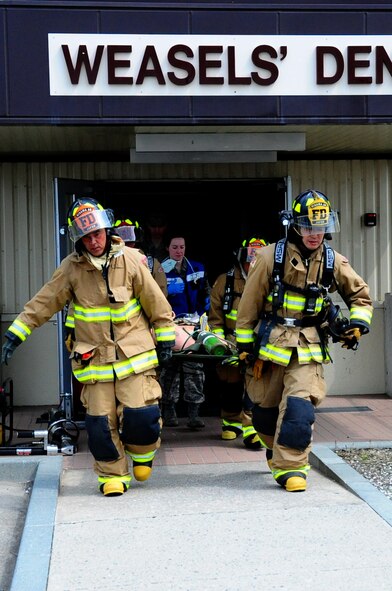 U.S. Air Force 35th Civil Engineer Squadron firefighters carry the last injured Airman out of the hazardous location after a simulated 7.1 earthquake during a base Emergency Management Exercise at Misawa Air Base, Japan, May 13, 2013. The EME was held in an effort to strengthen the capabilities of local response teams. (U.S. Air Force photo by Staff Sgt. April Quintanilla)