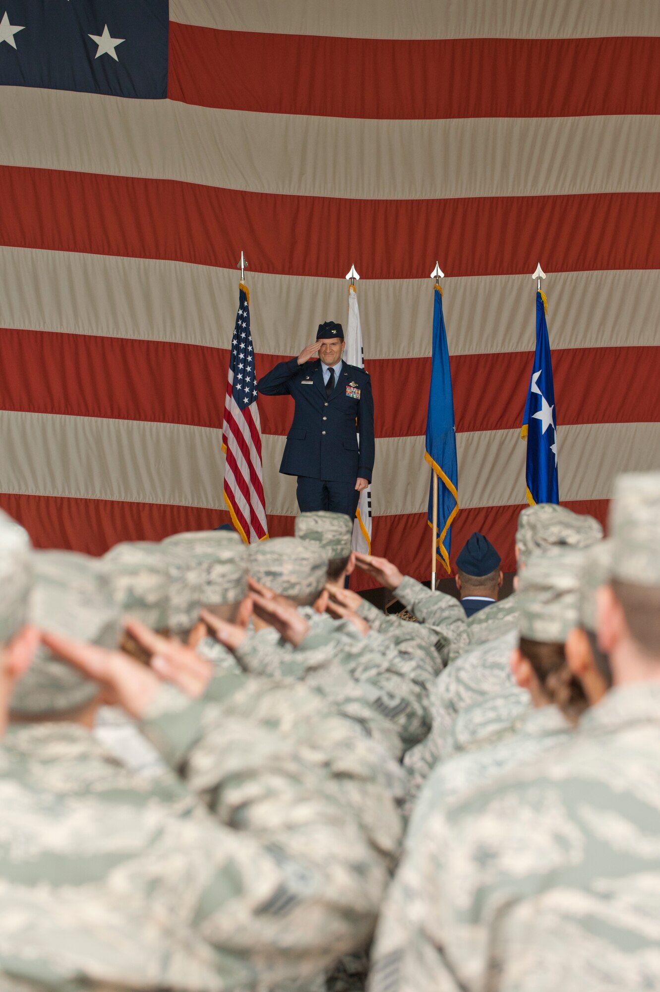 KUNSAN AIR BASE, Republic of Korea -- Col. S. Clinton Hinote salutes Airmen of the 8th Fighter Wing for the first time as their commander at Kunsan Air Base, Republic of Korea, May 10, 2013. Hinote assumed command of the 8th FW from outgoing commander Col. John W. Pearse.  (U.S. Air Force photo by Staff Sgt. Jonathan Fowler/Released)