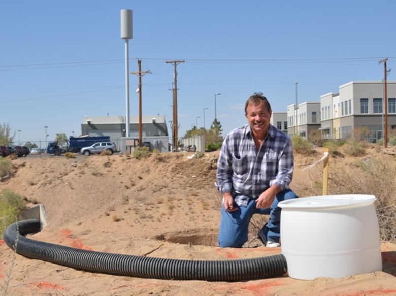 Eddie Paulsgrove, project manager, Regulatory Division, U.S. Army Corps of Engineers, with  the artificial flex pipe and barrel drum owl habitat prior to it being buried.