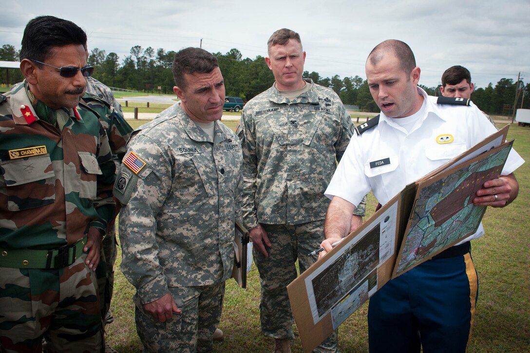 U.S. Army Capt. Kent Feda, right, briefs Indian army Brig. Gen. Jagdish Chaudhari, left, U.S. Army Lt. Col. Phillip Sounia, and U.S. Army Col. Trevor Bredenkamp before a reconnaissance helicopter flight during Yudh Abhyas 2013 on Fort Bragg, N.C., May 3, 2013. Feda is an air element officer assigned to the 82nd Airborne Division’s 1st Brigade Combat Team, Bredenkamp is a commander assigned to the 82nd Airborne Division’s 1st Brigade Combat Team, and Sounia deputy commander of the 82nd Airborne Division’s 1st Brigade Combat Team.