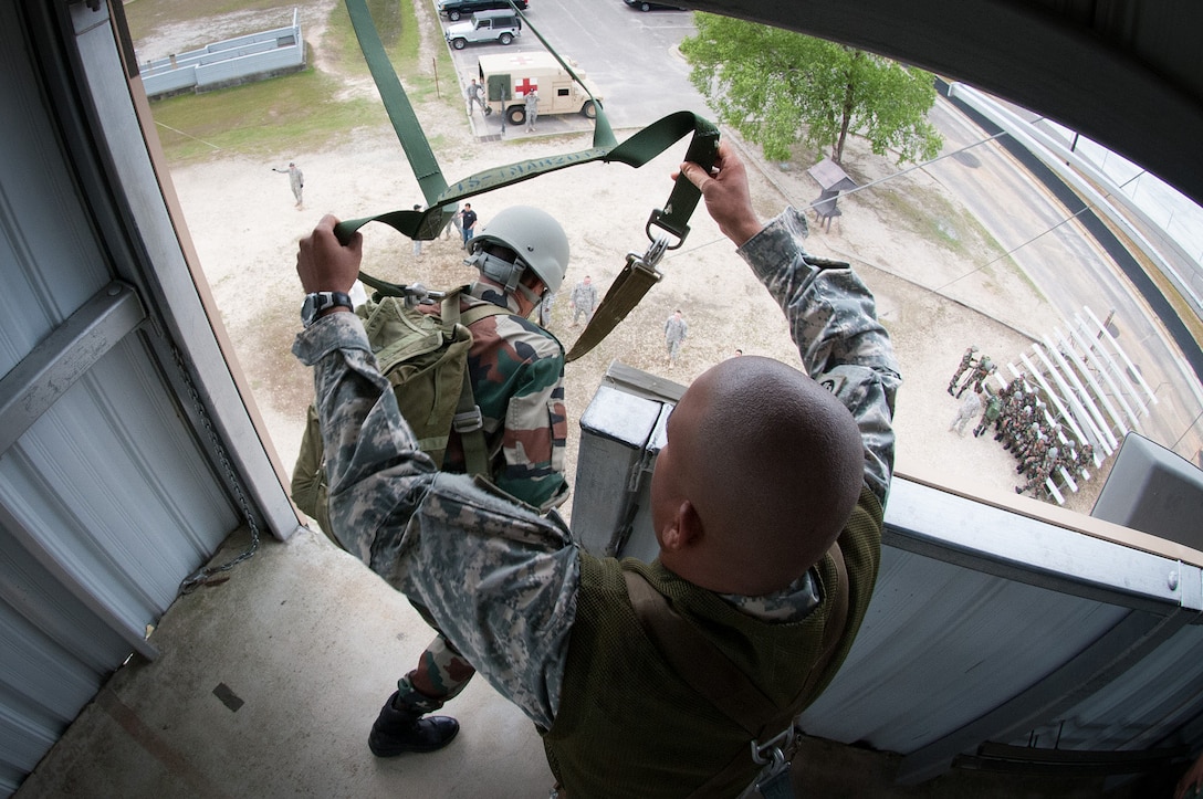 An Indian army paratrooper jumps from a 34-foot parachute training tower during airborne refresher training at the 82nd Airborne Division’s Advanced Airborne School during Yudh Abhyas 2013 on Fort Bragg, N.C., May 3, 2013.