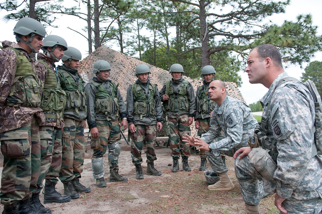 U.S. Army Sgt. Balkrishna Dave, second form right, explains weapons range safety procedures to Indian Army soldiers before they fire American machine guns at a range during Yudh Abhyas 2013 on Fort Bragg, N.C., May 4, 2013. Dave, an India-born U.S. Army paratrooper, is assigned to the John F. Kennedy Special Warfare Center and School.