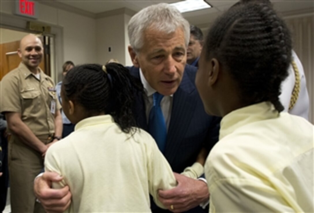 Secretary of Defense Chuck Hagel gets a hug and a question from 5th grade students from John Tyler Elementary School at the Spirit of Service shadow day at the Pentagon on May 10, 2013.  The students will participate in various activities throughout the day including Pentagon and Press Briefing Room tours, a luncheon with DoD representatives, and a demonstration by the Pentagon Force Protection Agency.  The students were selected by the school's administration for their best behavior.  